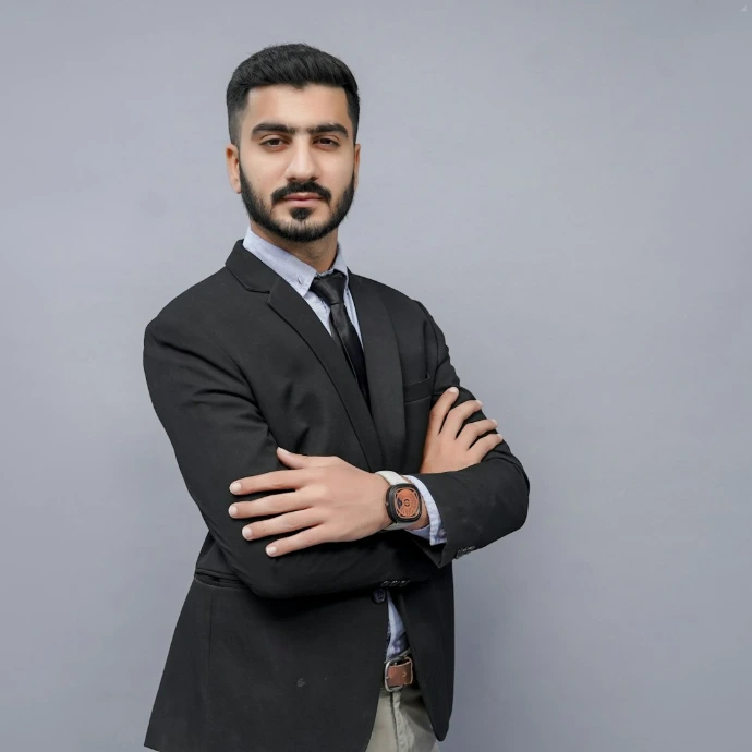 a man in a suit with his arms crossed
